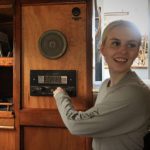 girl-adjusts-old-radio